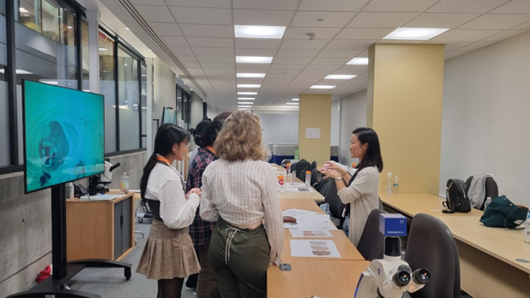 UNIQ students taking part in a pathology practical task led by oncology researchers